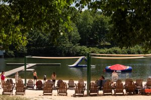 View of Lake Monocan from behind beach chairs.