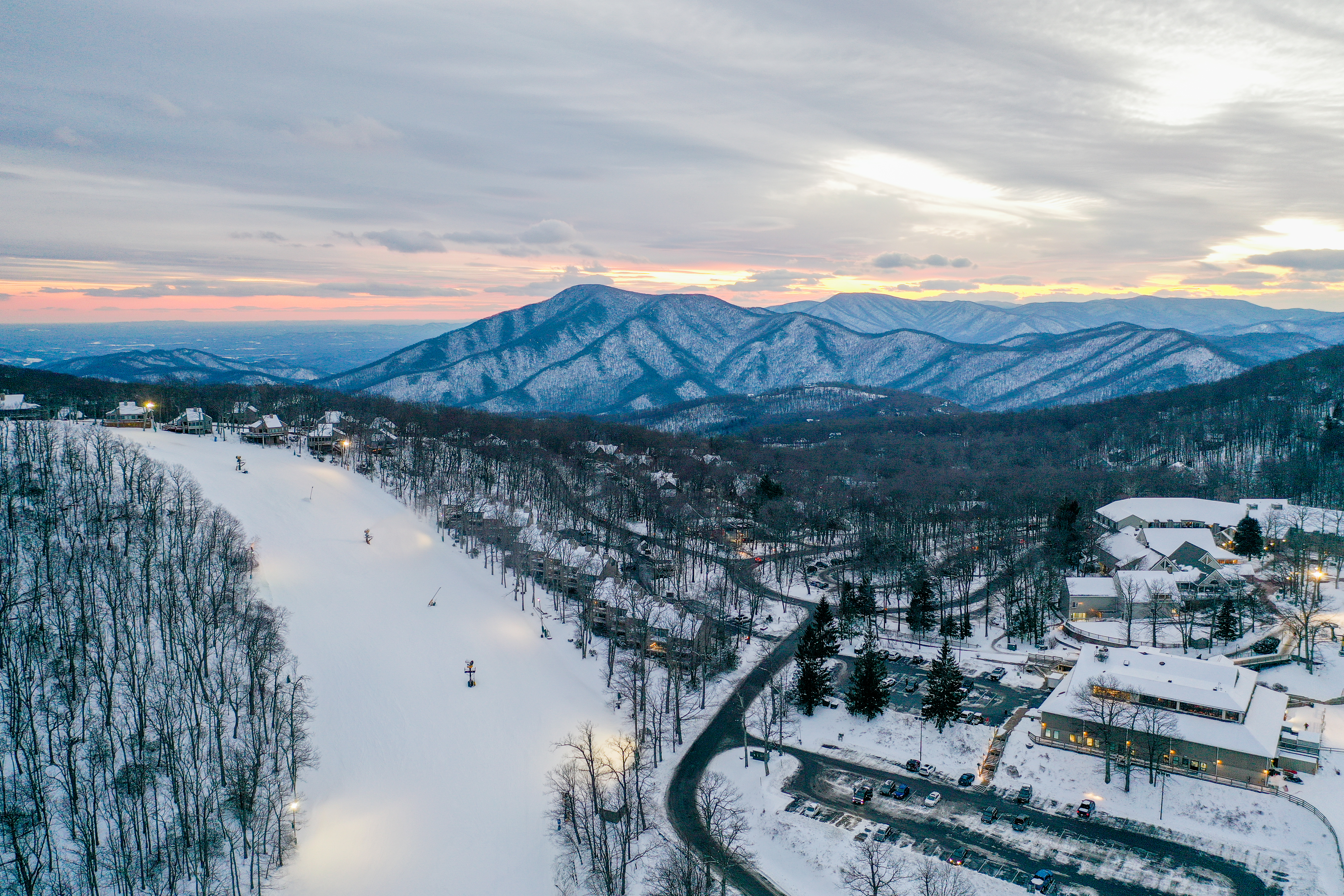 aerial view of ski slopes with sunset
